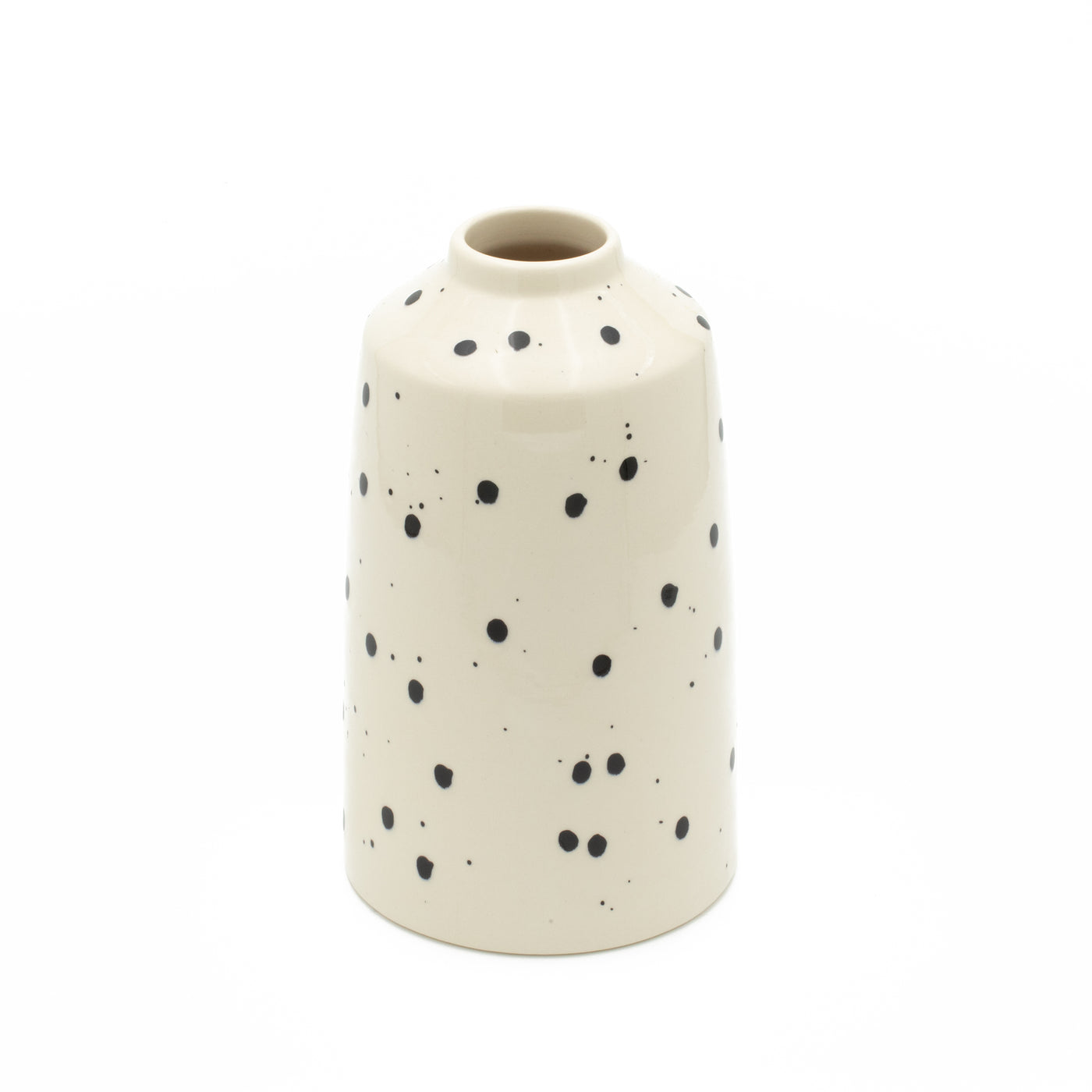 Black dotted flower vase with beige color cut out against a white background