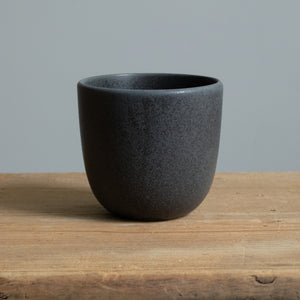 Matt black cappuccino mug on a wooden table