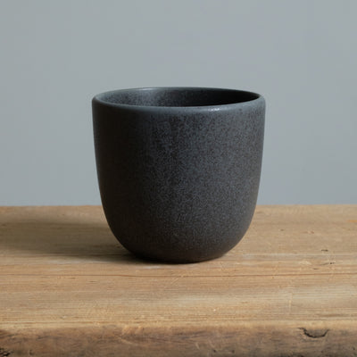 Matt black cappuccino mug on a wooden table