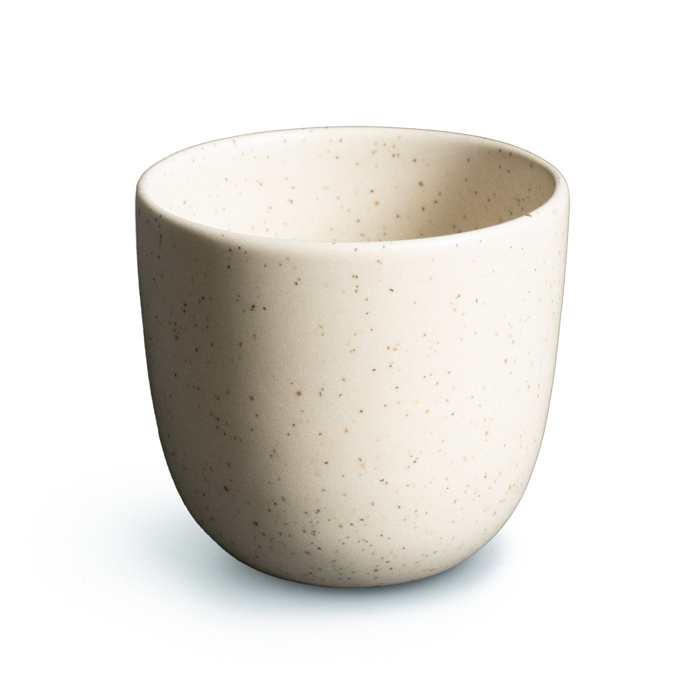 Beige coffee cup with fine sprinkles cropped against a white background