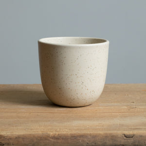 Cappuccino mug in matt beige on a wooden table