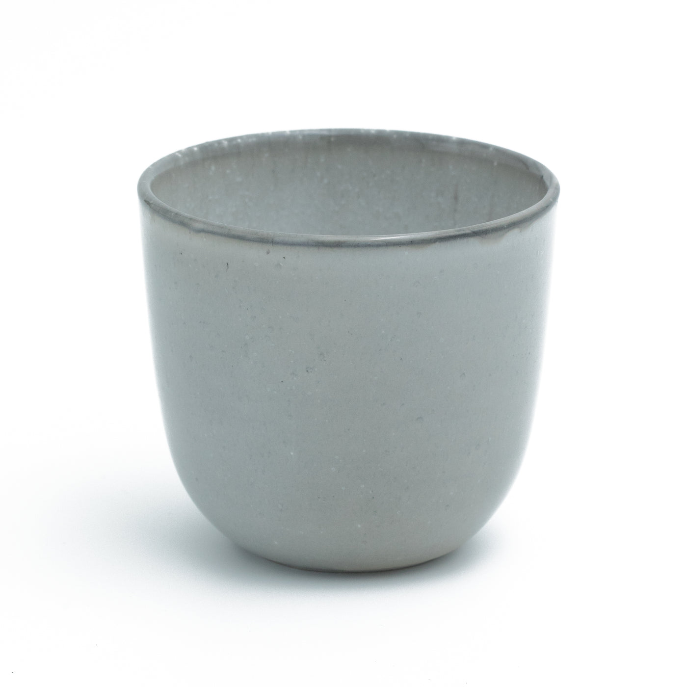 Light gray coffee cup without handle cropped against a white background