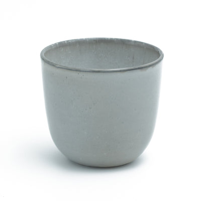 Light gray coffee cup without handle cropped against a white background