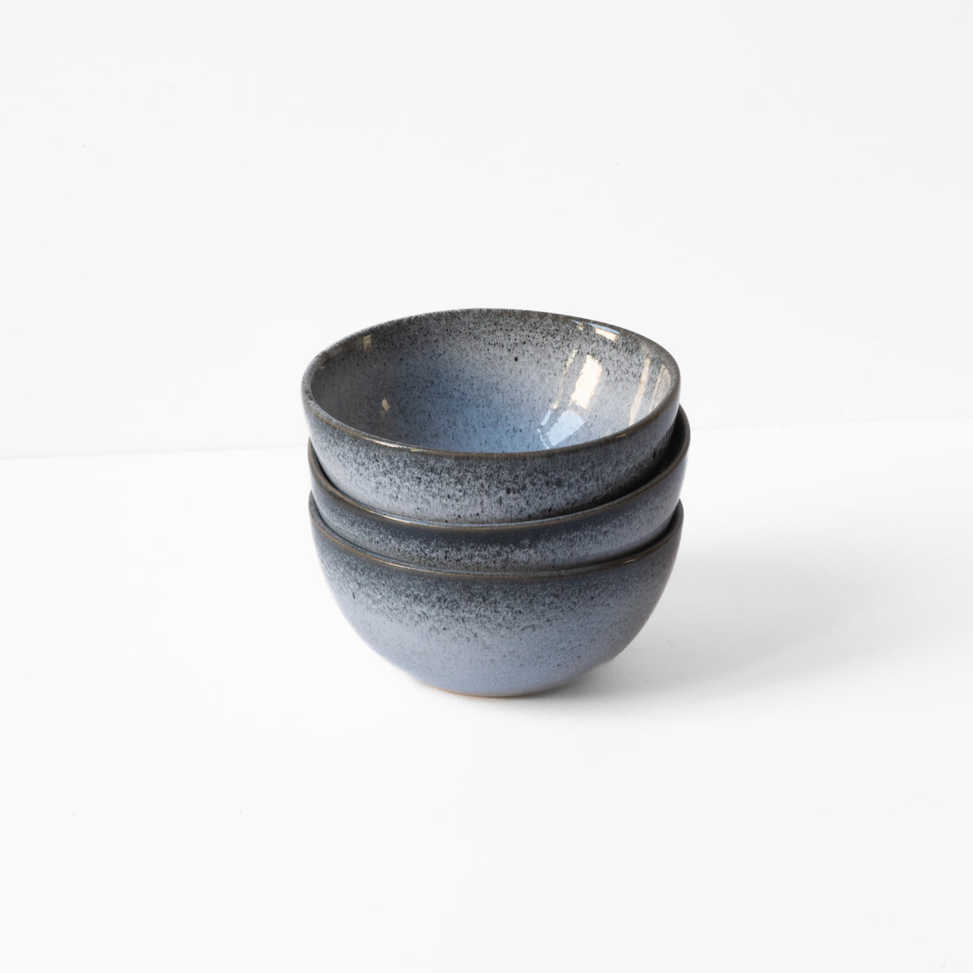 Stackable small bowls with blue reactive glaze