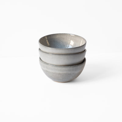 Three light gray small bowls stacked on top of each other 