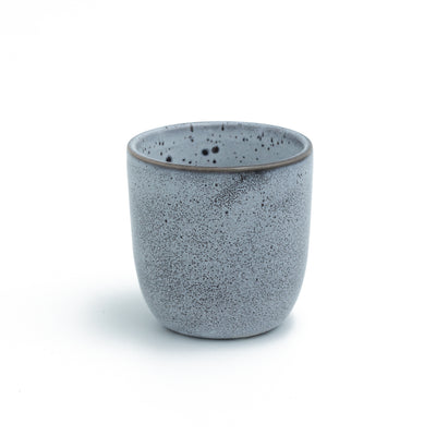 Blue espresso cup without handle cropped against a white background