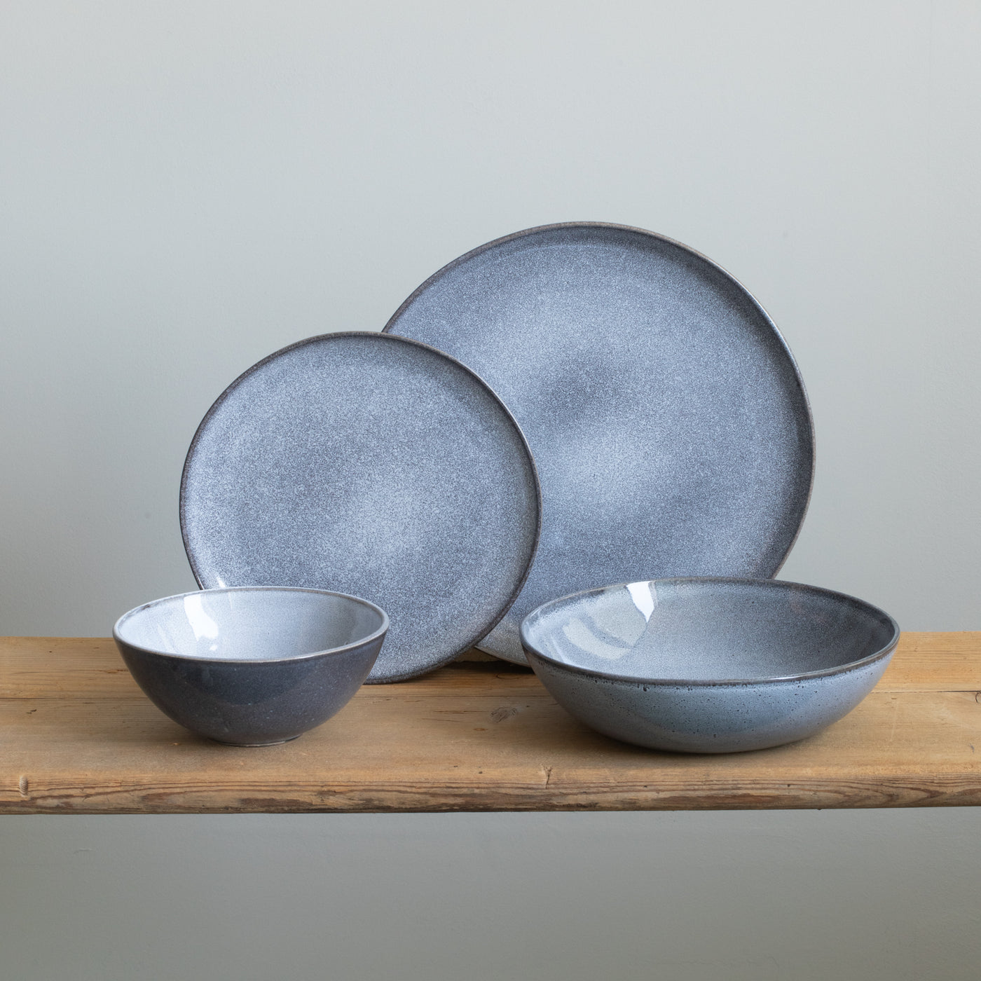 Complete stoneware tableware set with large and small plates, cereal bowl and pasta plate in mottled blue