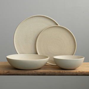 Complete tableware set in beige glaze with a large and small plate, a deep pasta plate and a muesli bowl
