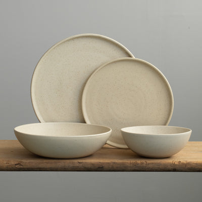 Complete tableware set in beige glaze with a large and small plate, a deep pasta plate and a muesli bowl