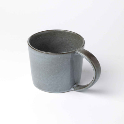 Gray-blue teacup with a handle looks like the stormy sea