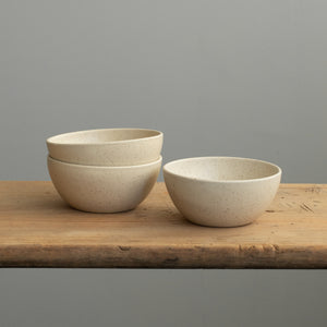 Three large snack bowls on a wooden board in matt beige