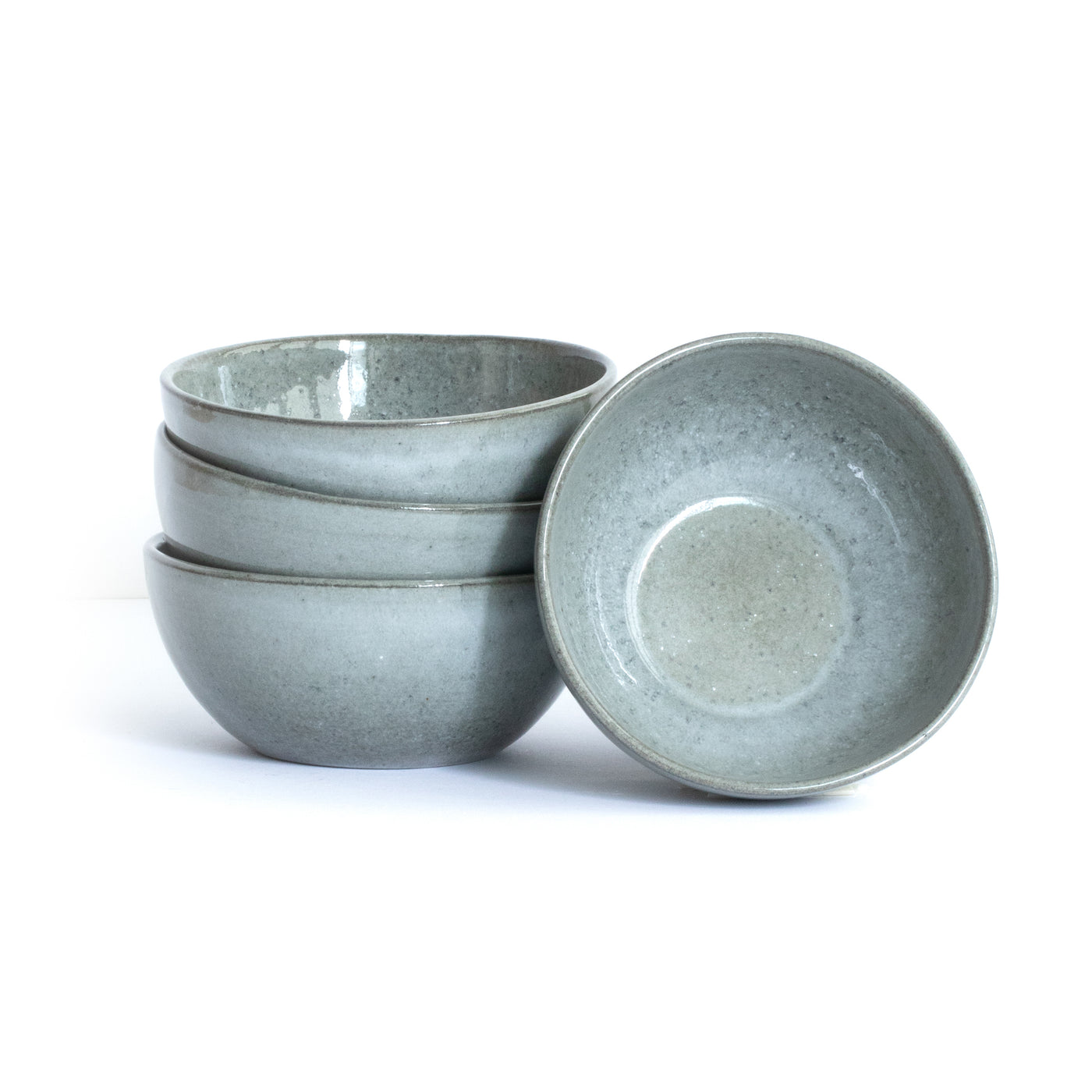 Dark gray large snack bowl in organic round shape placed and stacked in front of a white background