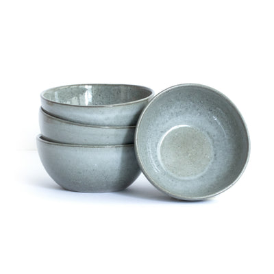 Dark gray large snack bowl in organic round shape placed and stacked in front of a white background