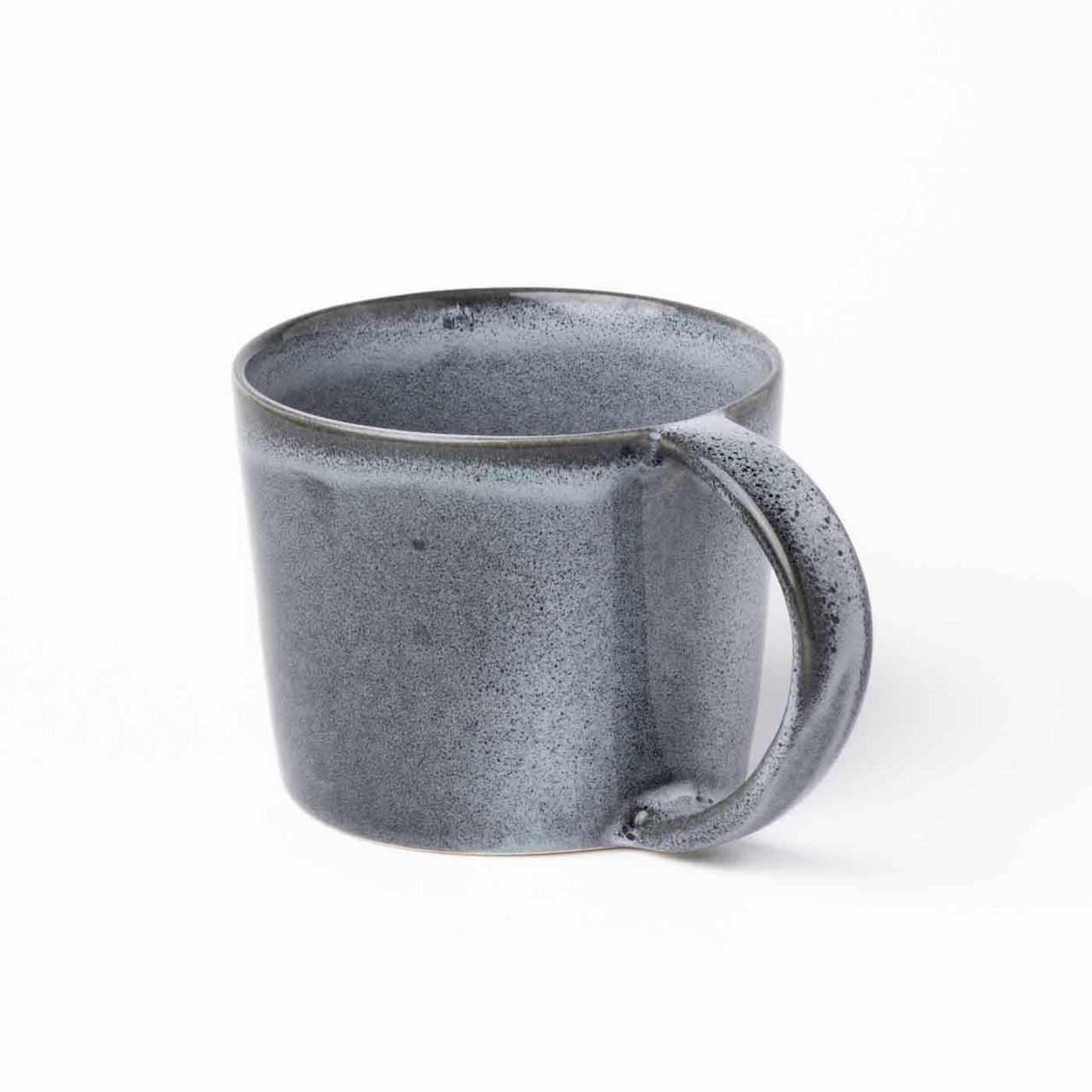 Large blue teacup with a handle that extends from the top to the bottom rim