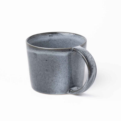 Large blue teacup with a handle that extends from the top to the bottom rim