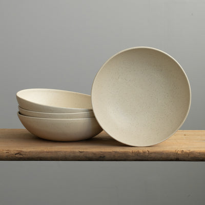 Large round deep pasta plate in matt beige glaze with fine sprinkles