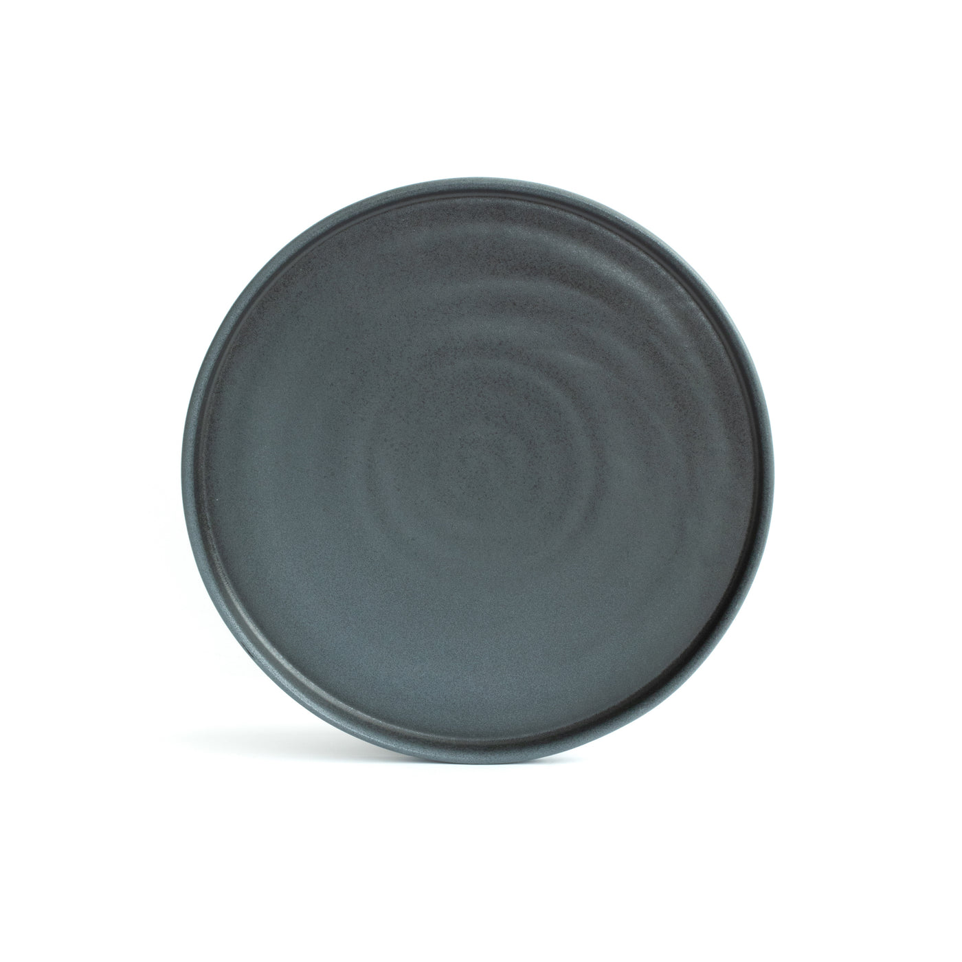 Large main course plate with straight edge placed and cropped in front of a white background