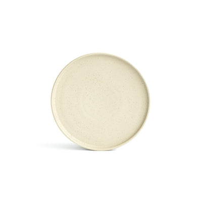 Small beige appetizer plate with straight edge, cropped against a white background