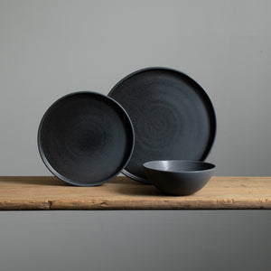 Tableware set with large and small plates and a cereal bowl in matt black