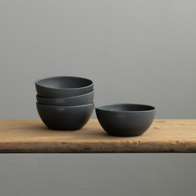 The large matt black snack bowls on a wooden board look elegant and are perfect for hummus and dips