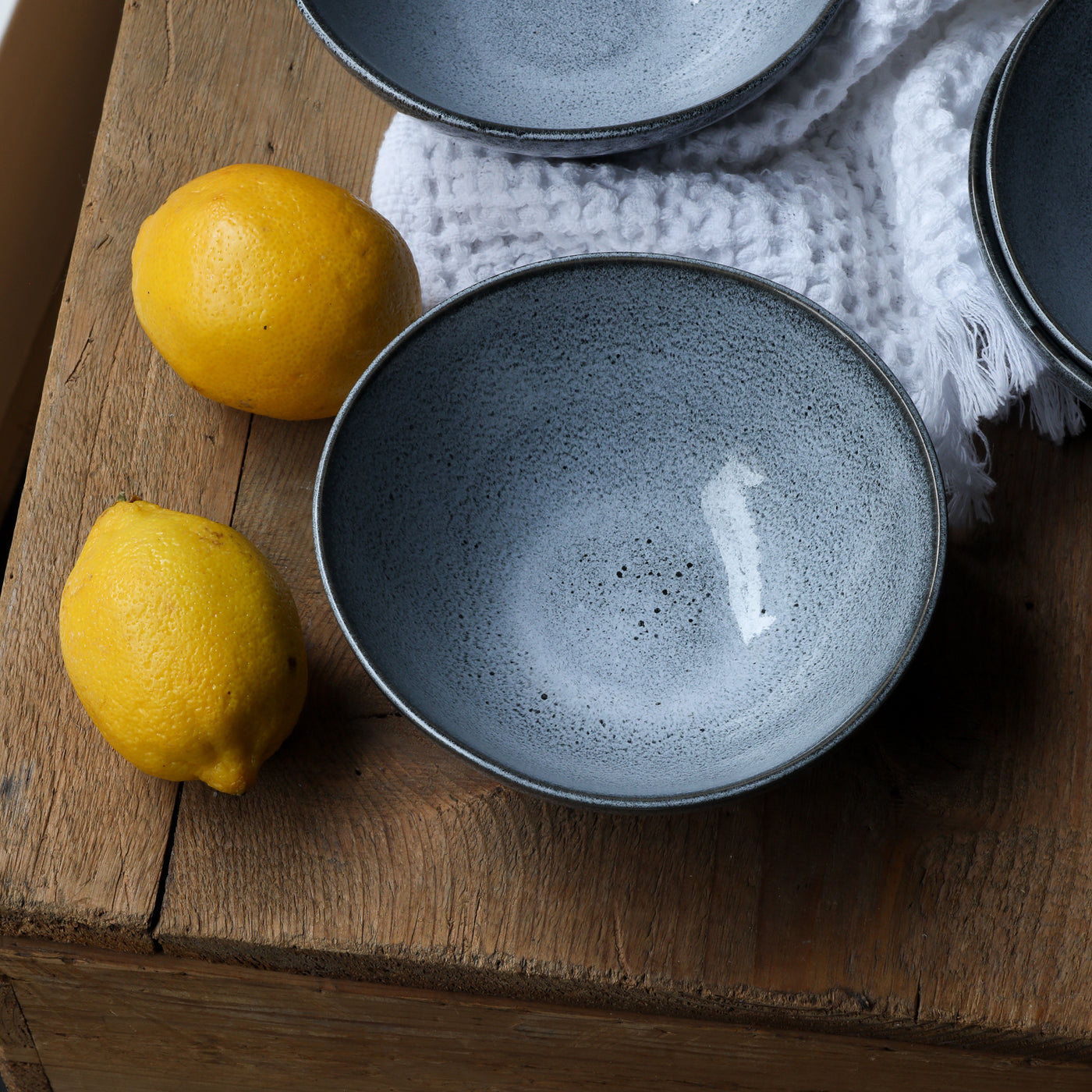 Stoneware bowl in blue reactive glaze next to a yellow lemon for a nice contrast to the blue