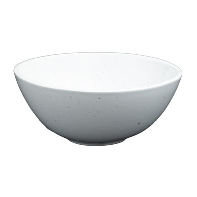White cereal bowl with golden dots against a white background.