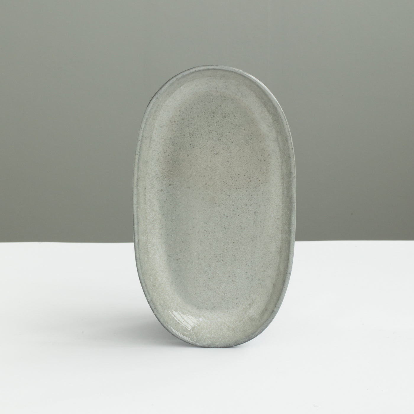 22cm long light gray oval plate set up perfectly as a saucer or starter plate made of stoneware