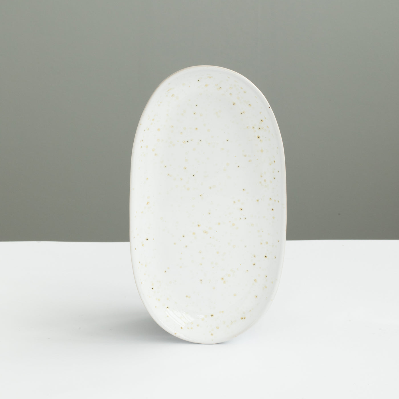 22 cm long oval plate perfect as a saucer or starter plate in white with golden brown spots