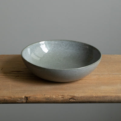 Deep plate in dark gray with blue stitch made of stoneware produced in Portugal