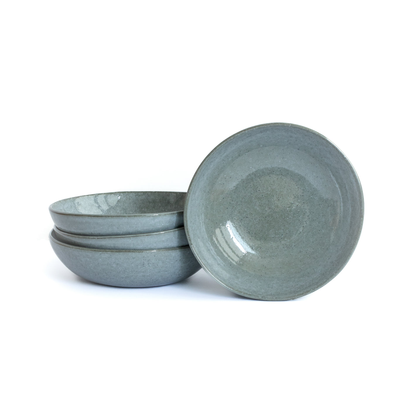 Dark gray blue pasta plate cropped against a white background