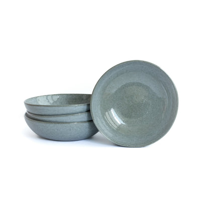 Dark gray blue pasta plate cropped against a white background