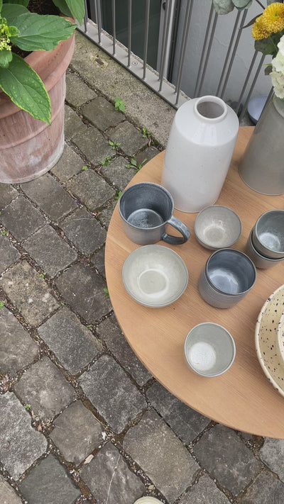 Large blue tea cup with handle is turned in all directions by one hand