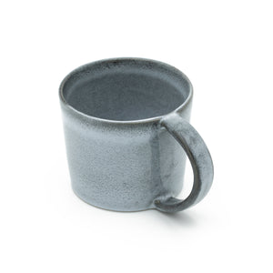 Large blue teacup with handle cropped against a white background