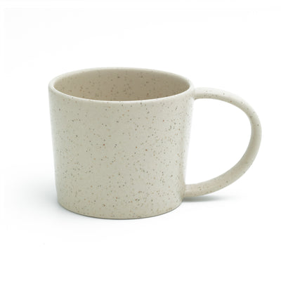 Matt beige tea cup with handle cut out against a white background