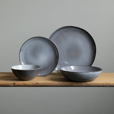 Complete stoneware tableware set with large and small plates, cereal bowl and pasta plate in mottled blue