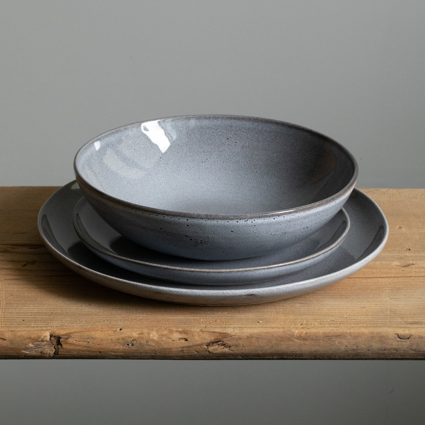 Tableware set with large main course plate, small starter plate and a pasta plate in blue color