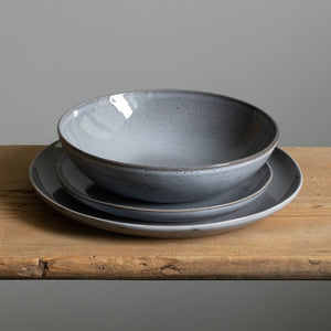 Tableware set with large main course plate, small starter plate and a pasta plate in blue color