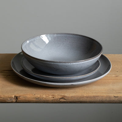 Tableware set with large main course plate, small starter plate and a pasta plate in blue color