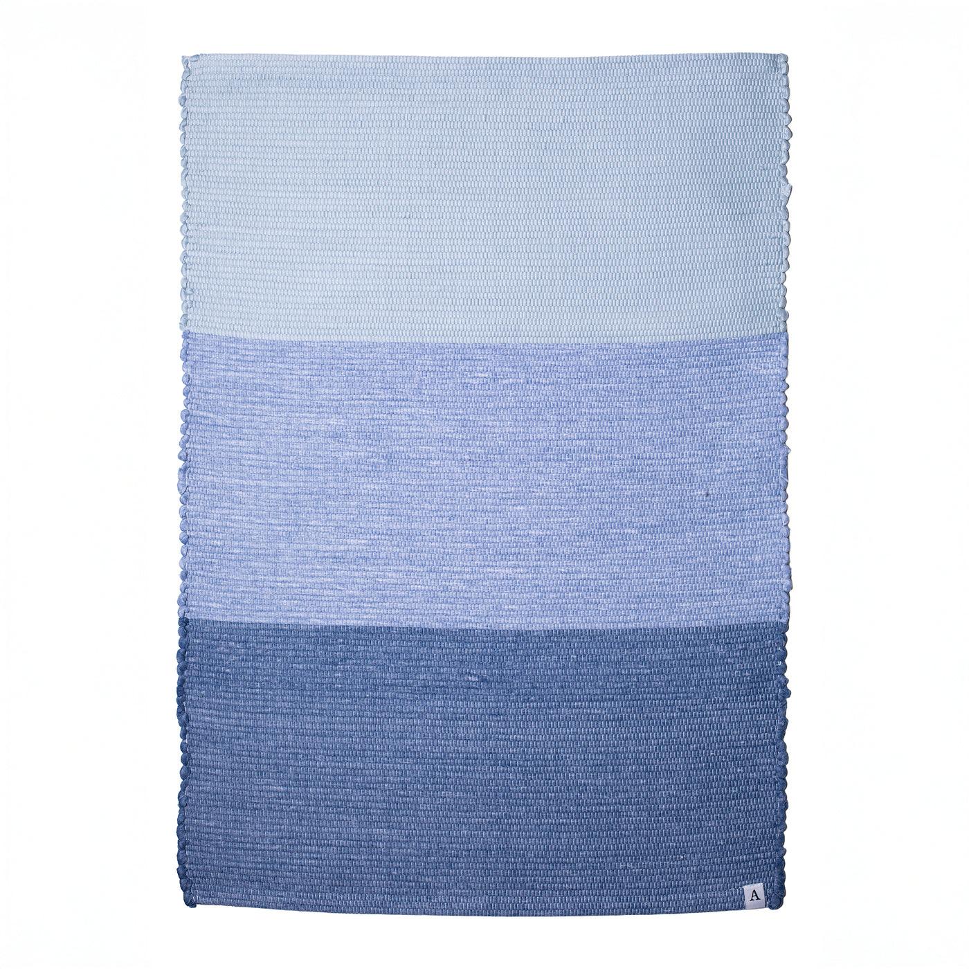 Hand-woven bathroom rug in 3 shades of blue set against a white background
