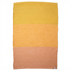 Bathroom rug made from recycled cotton in three shades of yellow and orange