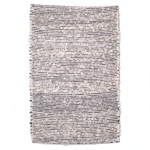 Striped two-tone bathroom rug made of white terrycloth with black stripes hand-woven in Portugal
