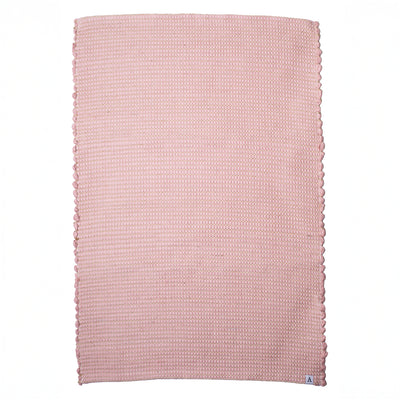 Small jute striped rug in antique pink made from wool remnants hand-woven in Portugal in front of a white background