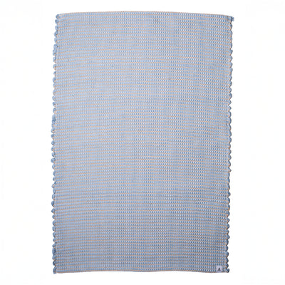 Small jute-striped rug in light blue made from wool remnants hand-woven in Portugal against a white background