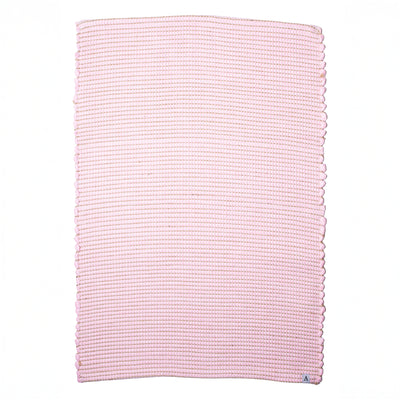 Small jute-striped rug in pink made from wool remnants hand-woven in Portugal against a white background